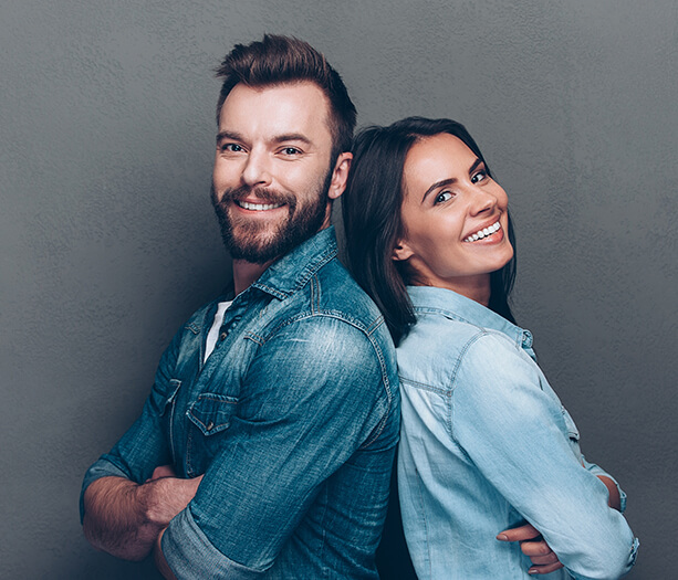 smiling man and woman back to back