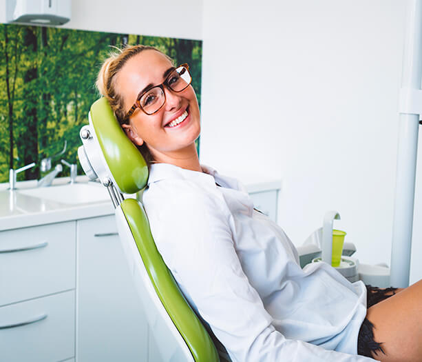 young woman smiling in dental chair