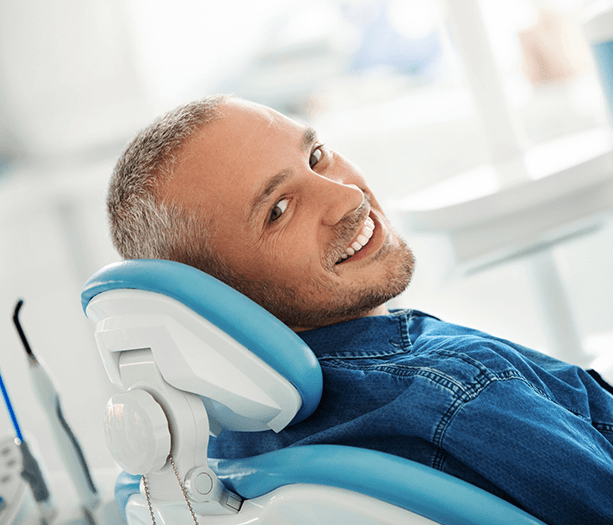 smiling man in dental chair