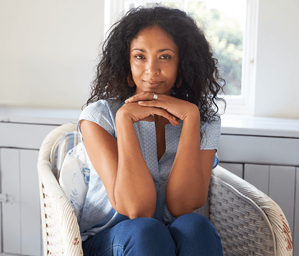 woman with face resting on hands