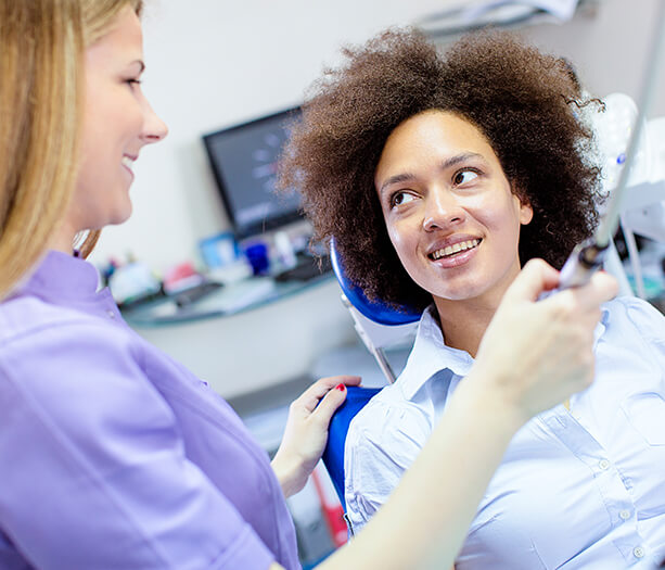 woman speaking with her dentist