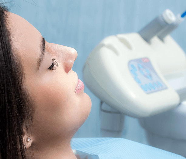 woman at the dentist with her eyes closed