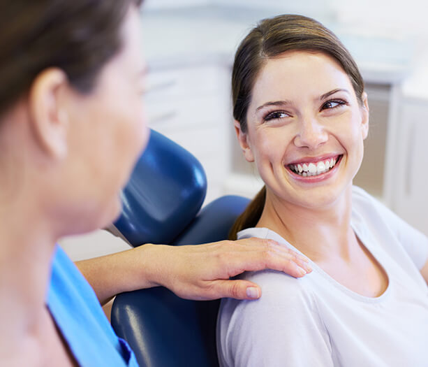 a woman at the dentist smiling