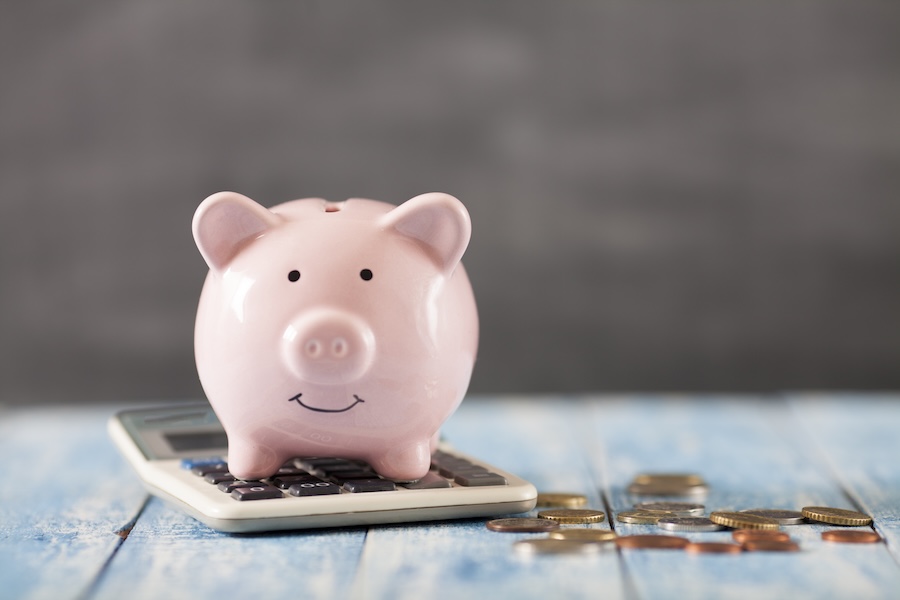 piggy bank and calculator to show savings from dental membership plan