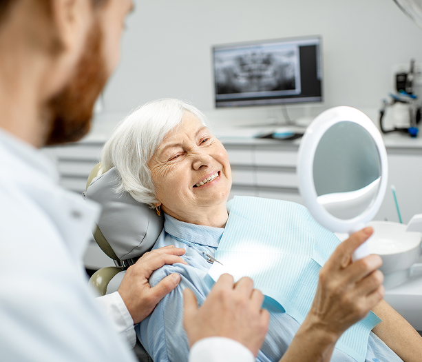 woman at the dentist looking in mirror